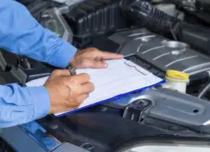 Checking off items on car road trip checklist.