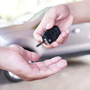 Turo host handing car keys to Turo car renter