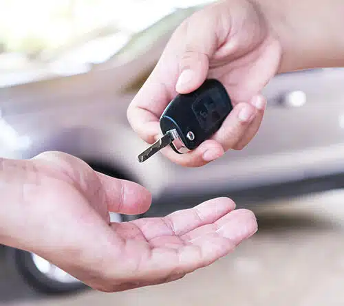Turo host handing car keys to Turo car renter